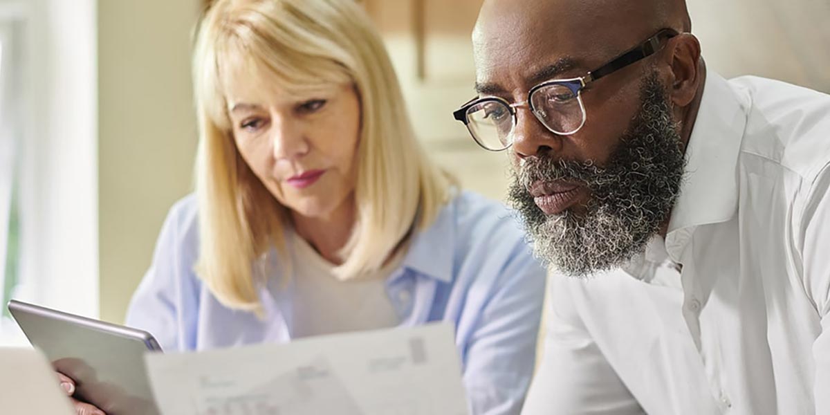 Two people reviewing information on new retirement contribution limits in 2026
